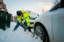 Mark Smith digs his car out of the snow to attempt to get to work on Windsor Terrace, Perth on March 1 2018.