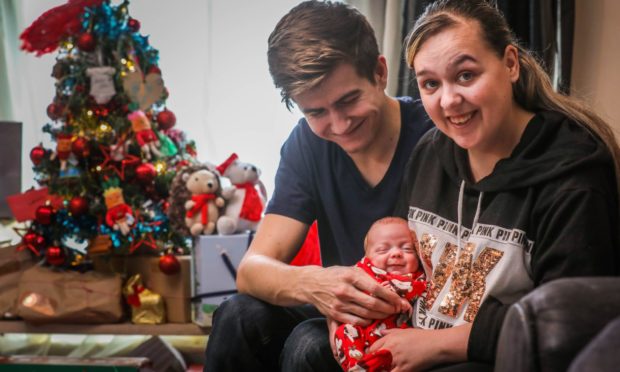 Baby Lewis, 10 weeks, with mum Bella and dad Lewis.