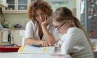 Mother helping daughter with her homework at the table in the dining room. Home Schooling concept.; Shutterstock ID 425607454