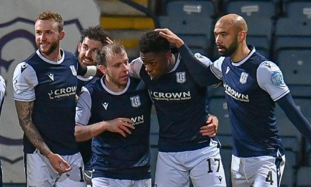 Jonathan Afolabi (second right) is mobbed by Dundee team-mates.