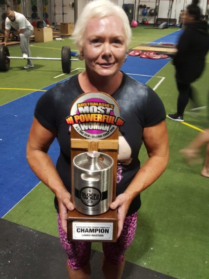 Susan Holland-Keen with one of her strongwoman trophies.