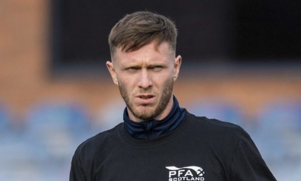 DUNDEE, SCOTLAND - OCTOBER 24: Dundee's Jordan McGhee warms up with Show Racism the Red Card t shirt during a Scottish Championship match between Dundee and Greenock Morton at Dens Park, on October 24, 2020, in Dundee, Scotland (Photo by Ross Parker / SNS Group)