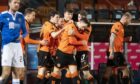 Lawrence Shankland is mobbed by teammates after his amazing equaliser.