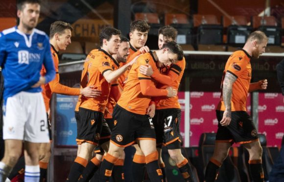 Lawrence Shankland is mobbed by teammates after his amazing equaliser.