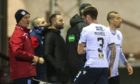 James McPake looks on as Dundee midfielder Jordan McGhee goes off injured against Arbroath.