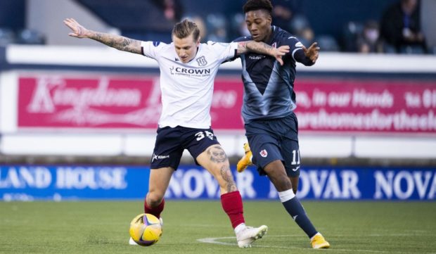 Jason Cummings battles with Raith player Timmy Abraham.