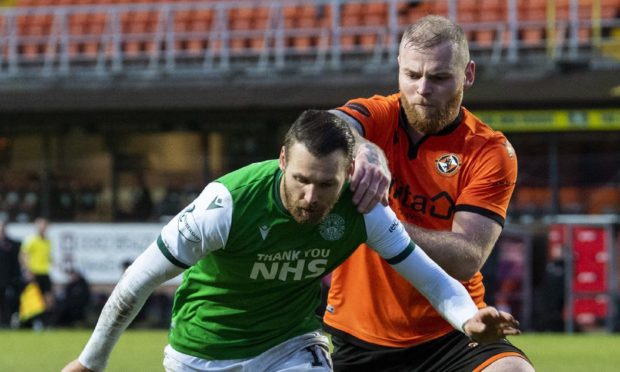 Dundee United defender Mark Connolly challenges Hibs winger Martin Boyle.