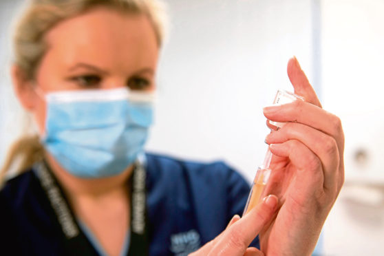 Advanced nurse practitioner Justine Williams prepares a dose of the AstraZeneca/Oxford Covid-19 vaccine. Pic by Andy Buchanan/PA Wire