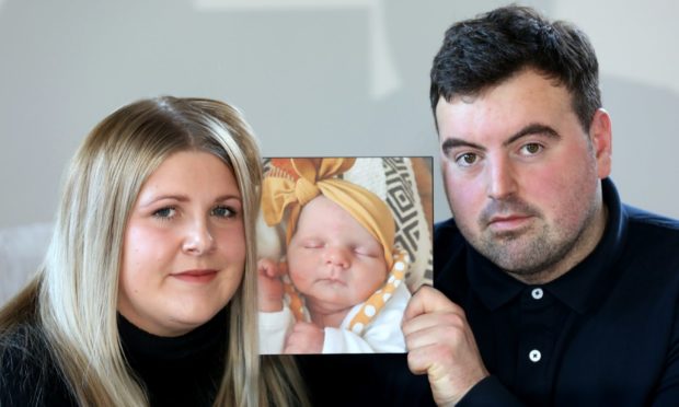 Megan and Kris with their favourite picture of Eva.