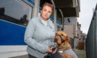 Joanne Robertson and her therapy dog Buddy at the charity's Cowdenbeath base which has been destroyed by flooding.