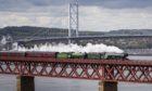 A Victorian train, The Flying Scotsman, travels on a Victorian span, the Forth Bridge, in 2020.
