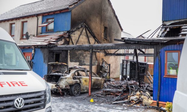 The fire-damaged house on Alexander Drive.