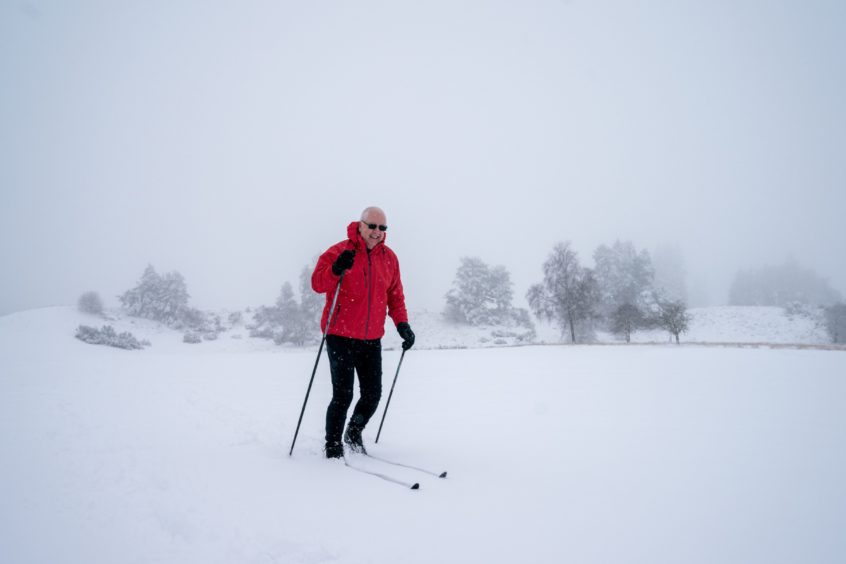 Douglas Hamilton, who was supposed to tee off at 9.50am, finds another means of exercise as he skis around the golf course at Gleneagles this morning.