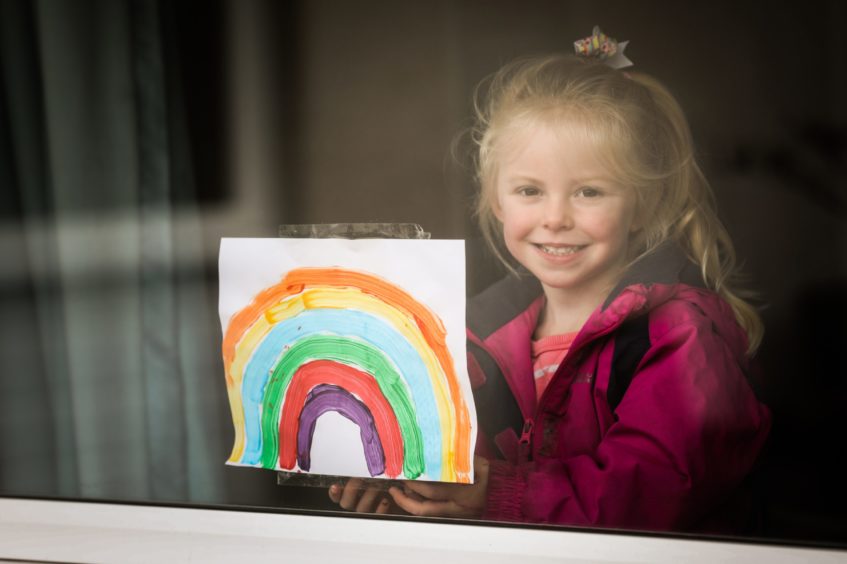 Poppy Stephenson, 3, putting a rainbow in the window. Mhairi Edwards/DCT Media