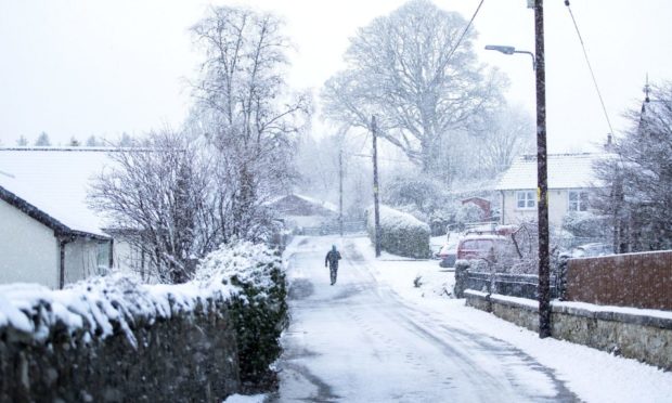 A man walks through the snow in Killin on Sunday, December 27.