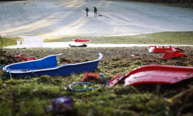 Discarded, broken sledges at Caird Park.