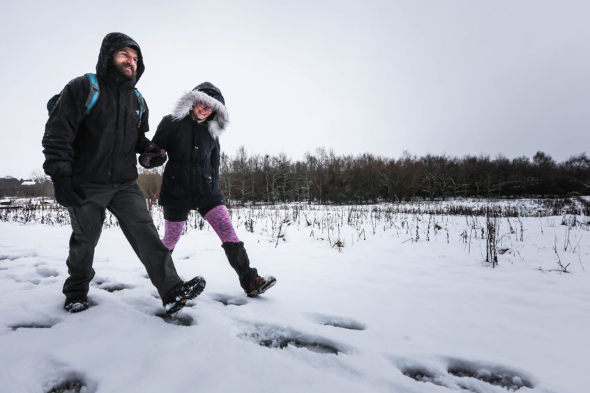 Karolina Jania and Brian Keith start their walk up the snowy Sidlaw Hills on Thursday, January 14 2021.