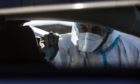 Mandatory Credit: Photo by ANGELO CARCONI/EPA-EFE/Shutterstock (11714812a)
A health worker wearing overalls, a protective mask and a face visor performs swab tests on motorists