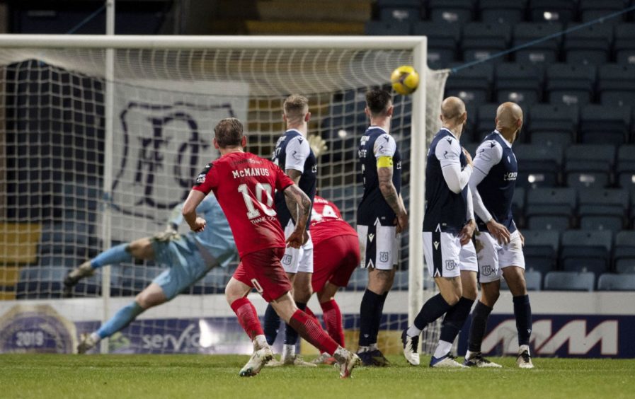 Declan McManus scores a last-minute equaliser against Dundee at Dens Park.