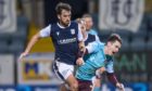Shaun Byrne challenges Jamie Walker as Dundee beat Hearts 3-1.