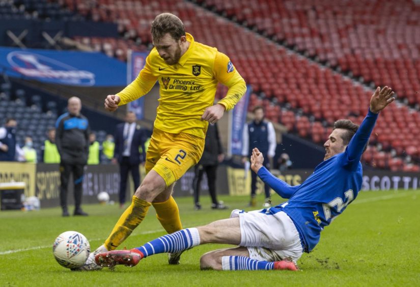 Livingston's Nicky Devlin (left) is tackled by St Johnstone's Callum Booth during the Betfred Cup final. 