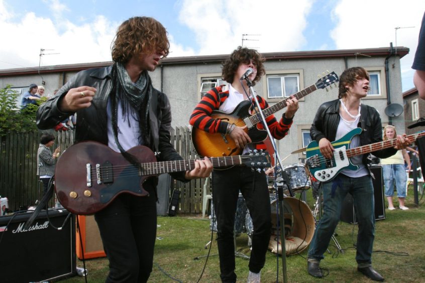 photo shows Dundee band The View playing musical instruments on a grassy area in the Dryburgh area of Dundee.