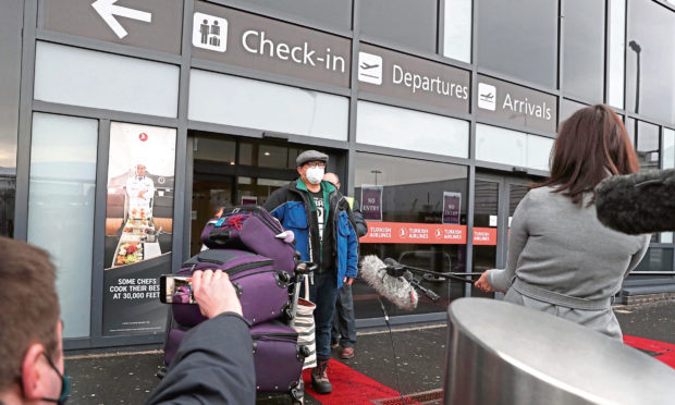 Chun Wong and his daughter Kiernan, 8, leave Edinburgh Airport.