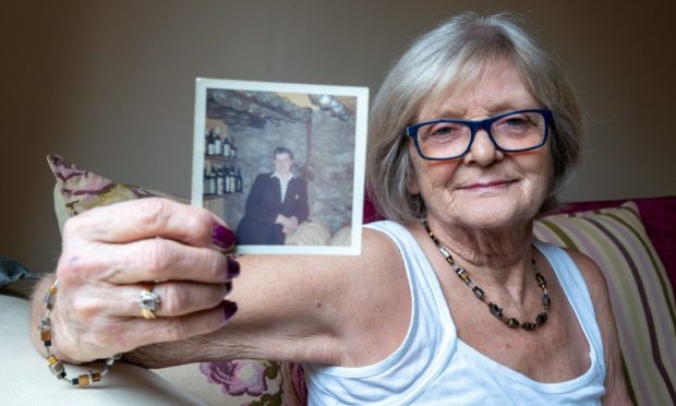 Alison Sibbald with a photo of her brother, who wrote the message more over 55 years ago.