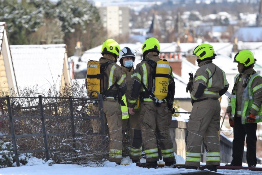 Firefighters attend at a garage in Cavendish Avenue, Perth in February 2021.