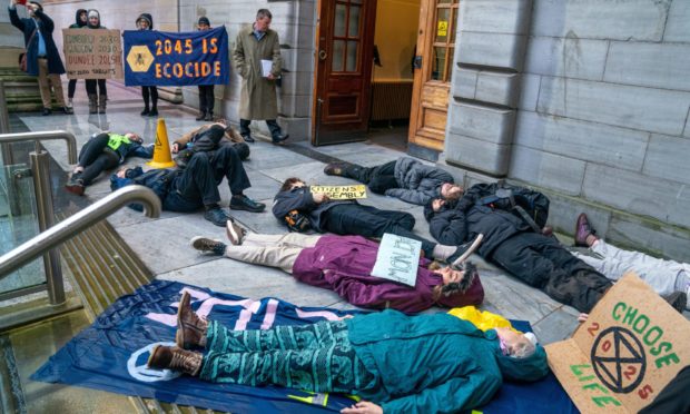 Extinction Rebellion gathered for a "die-in" outside the city chambers ahead of a Dundee City Council meeting.