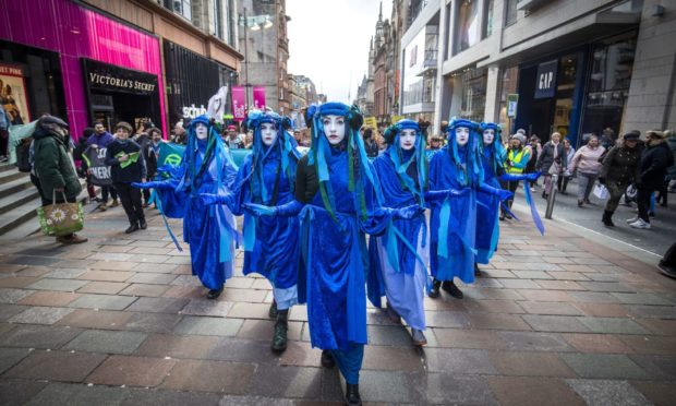 The Blue Rebels lead hundreds of people in the Blue Wave parade, organised by Extinction Rebellion, through Glasgow city centre.