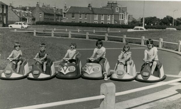 Children line up for a racing start at the Castle Green car track in 1975.