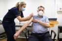James Shaw, 82, was the first person in Scotland to receive the Oxford AstraZeneca vaccine from nurse Justine Williams at the Lochee Health Centre in Dundee
