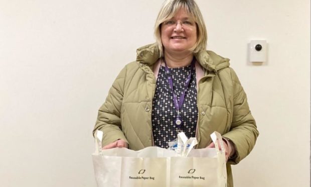 Community support officer Morag Paterson with the groceries on offer.