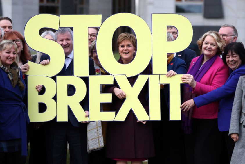 Nicola Sturgeon and fellow SNP candidates with a large Stop Brexit sign.