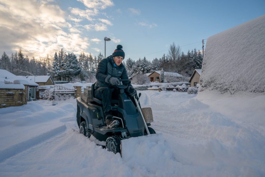 Dean Drew clears the access road to his cul-de-sac using his homemade snow plough in Perth on Wednesday, February 10 2021.