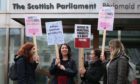 Monica Lennon MSP, second left, joined by supporters of the Period Products bill at a rally outside Parliament in Edinburgh in February 2020.
