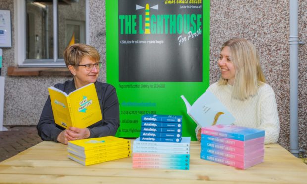 Sharon Thomas (left, manager) and right is Claire Dywalec (Volunteer Coordinator) with some of the titles / books at The Neuk, St Pauls Square, Perth.