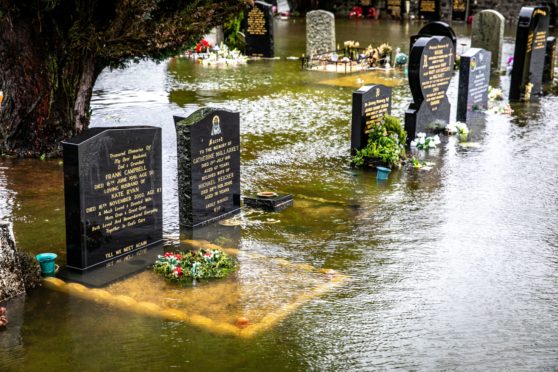 Graves and memorials lie under inches of water as flooding happens again at Ballingry Cemetery on Hill Road.