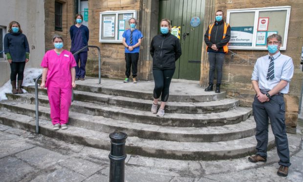 Cupar doctors, Sara McQuitty, Callum Duncan, Kirsty McQuitty, Steven Macfarlane, Hannah Dakin and former Bell Baxter pupils, Sean Colgan (High Vis) and Tara Gibson (front centre) at the Cupar Corn Exchange where they are vaccinating people from Covid-19 on Saturday.