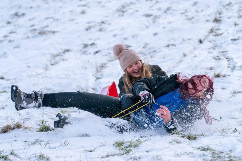 Erin McCormack (13) and Abi Grieve (12) race down the slopes in Newburgh, Fife.