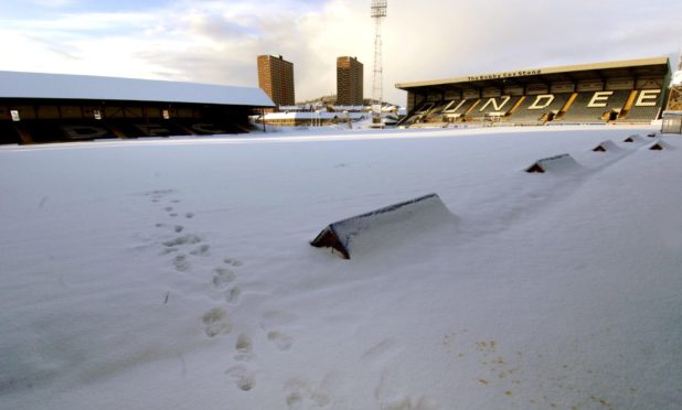 A library photo showing Dens Park covered in snow in 2014.