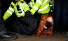 A woman is arrested at a vigil in memory of Sarah Everard, Clapham, London.
