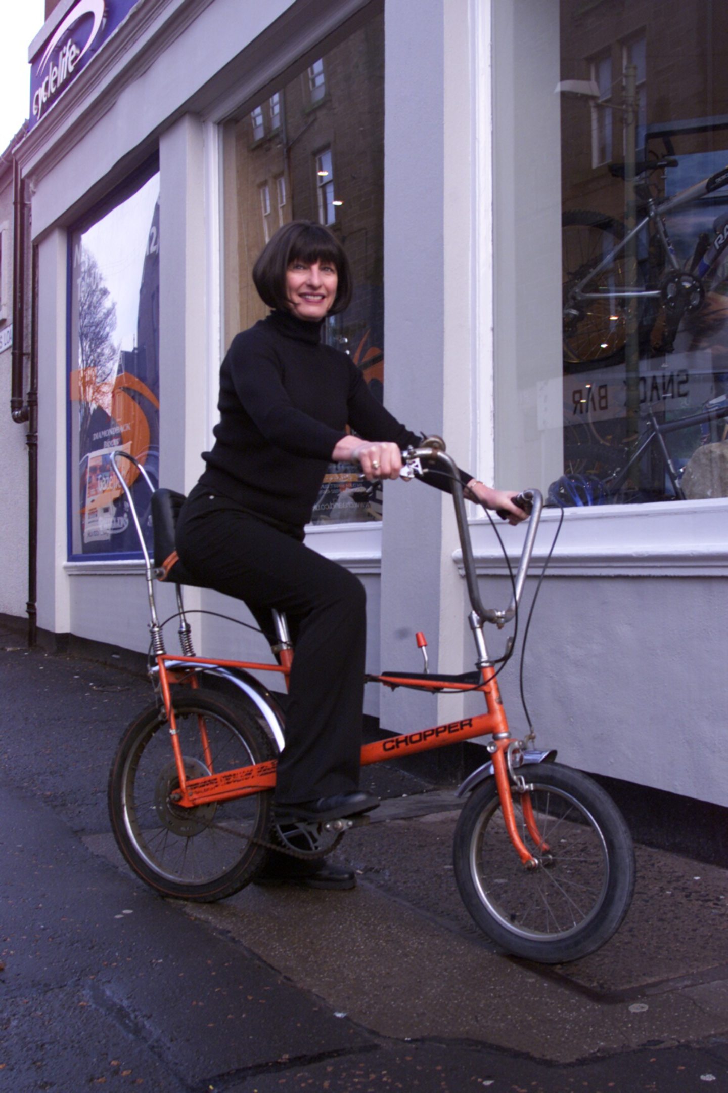 Margaret Williams on a Raleigh Chopper outside Nicholson's in Dundee