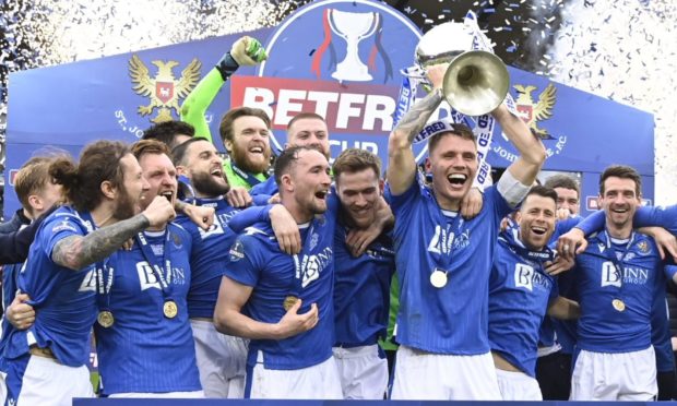 St Johnstone captain Jason Kerr holds aloft the Betfred Cup.