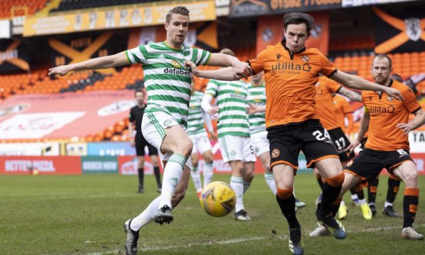 Lawrence Shankland and Celtic's Kris Ajer close in on the ball.