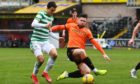 Dundee United midfielder Calum Butcher competes with Mohamed Elyounoussi for possession.