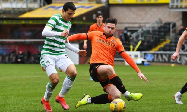 Dundee United midfielder Calum Butcher competes with Mohamed Elyounoussi for possession.