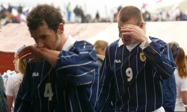 Christian Dailly (left) and Kevin Kyle look inconsolable after Scotland's humiliating 2-2 draw in the Faroe Islands back in 2002.