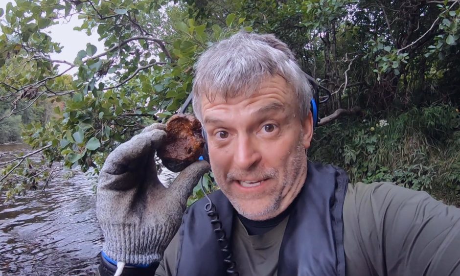 Beau Ouimette shows off the relic of the hand grenade which was discovered in Perthshire.